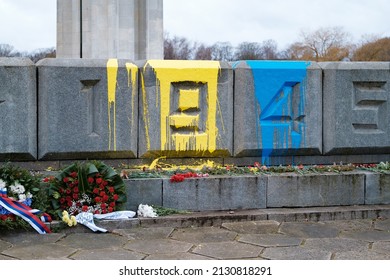 RIGA, LATVIA, FEBRUARY 25. 2022 - The so called "Victory monument" defaced with paint in colors of Ukrainin flag.