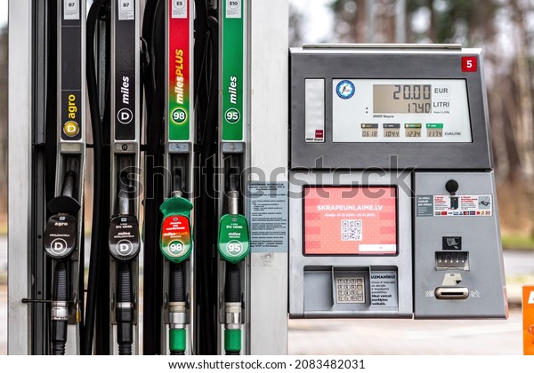Riga, Latvia, January 2, 2021: Circle K gas station\
with fuel, oil, gasoline and diesel, close-up of a petrol pump\
fueling gun