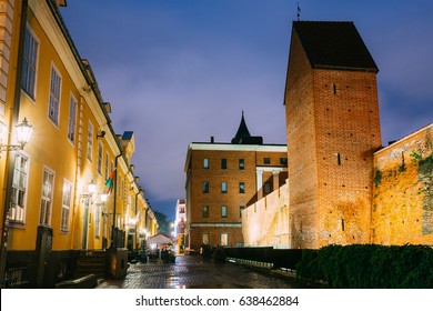 Riga, Latvia - July 3, 2016: Facades Of Old Famous Jacob's Barracks And Part Of Old The City Wall In Torna Street In Lighting At Evening Or Night Illumination In Old Town. Blue Hour