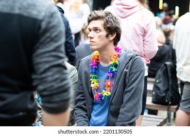 Riga, Latvia, June 18, 2022: Young People Gathering At Pride Festival In The City. Man With Hawaii Flower Wreath