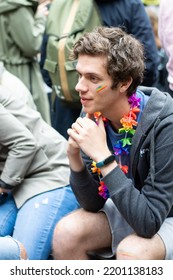 Riga, Latvia, June 18, 2022: Young People Gathering At Pride Festival In The City. Man With Hawaii Flower Wreath