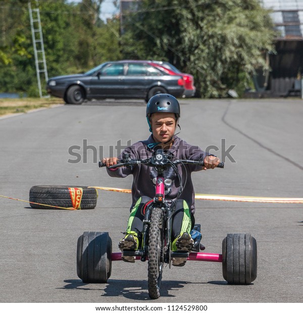 Riga. Latvia. June\
30, 2018. The Gold Barbell children`s festival of sports. The boy\
learns to drive a car.
