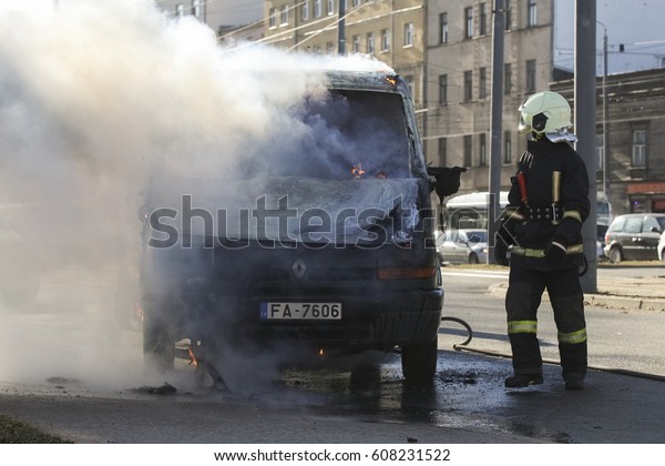 RIGA, LATVIA - MARCH 24, 2017:\
Burning van with large flames and black smoke in Riga,\
Latvia