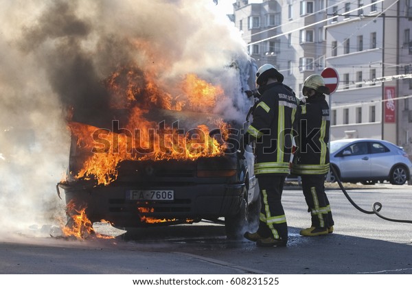 RIGA, LATVIA - MARCH 24, 2017:\
Burning van with large flames and black smoke in Riga,\
Latvia