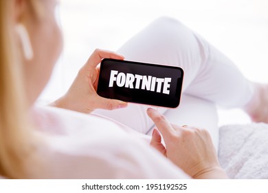 Riga, Latvia - March 26, 2021: Woman Holding Phone With Fortnite Logo On The Screen