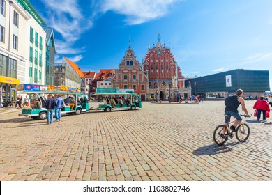 RIGA, LATVIA - MAY 06, 2017: View On Riga Town Hall Square And Small Tourist Bus That Are  Located In The City Center Of Riga