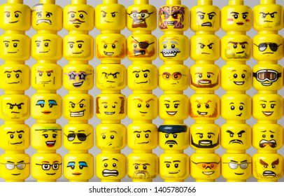 Riga, Latvia - May 22, 2019: Different LEGO minifigure heads stacked side-by-side and one on top of each other. This shows the evolution of LEGO minifigure head prints through the years.