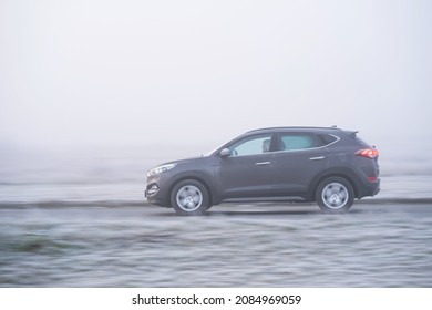 Riga, Latvia - November 15, 2021: SUV Driving On A Foggy November Morning At The Scenic Road, Motion Blurred Background