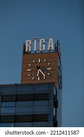 Riga, Latvia  October 10th 2022 
 Riga Station And Origo Shopping Centre Clock Tower At 6.25pm With A Riga Sign Above