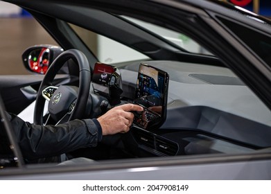 Riga, Latvia, Sep 24, 2021: Inside View Of The Volkswagen (VW) ID4 Electric Car, Driver Setting Up Satnav Using Touchscreen