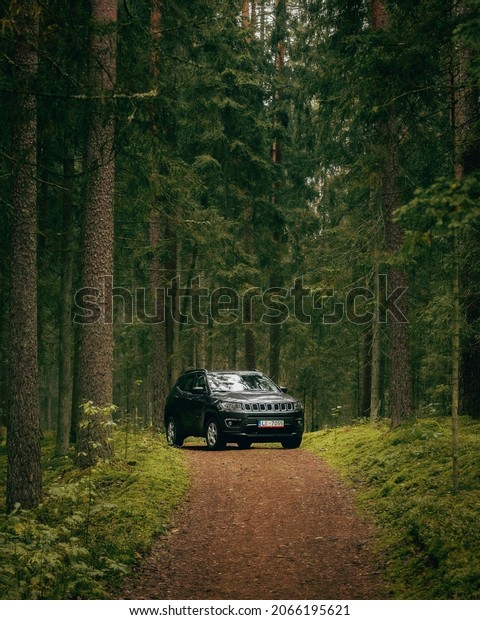 Riga, Latvia - September 12 2021: New Jeep Compass\
SUV in forest