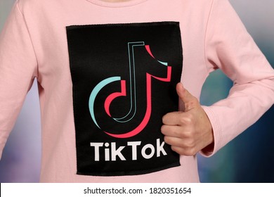 Riga, Latvia - September 21, 2020: Tik Tok Icon Social Media Logo On Pink Girl T-shirt.Tik Tok Logo Design.