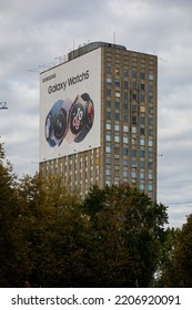 Riga, Latvia  September 25th 2022 A Derelict Soviet Era Apartment Building Ready For Demolition, With Large Advertising Billboard Promoting The Samsung Galaxy Watch5