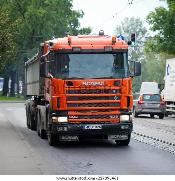 RIGA - SEP 8: Scania 114G V8 530 truck on a road\
on Sep. 8, 2014 in Riga, Latvia. Scania is a major Swedish\
automotive manufacturer of commercial vehicles - specifically heavy\
trucks and buses.