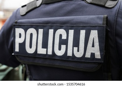 Riga/Latvia - August 29, 2019: Close Up Of Latvian Police Officer With Text POLICIJA