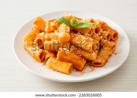 Rigatoni pasta with tomato sauce and cheese - traditional Italian pasta