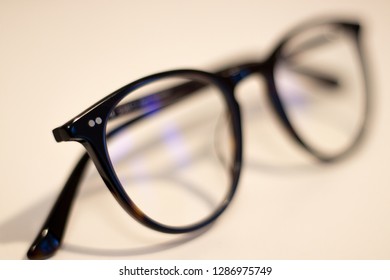 Riga,Vidzeme,Latvia 01.02.2019 Modern Glasses, With Blue Reflection In The Glass Itself. Black Glass Frames. Blue Light Filter Glasses.