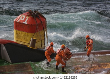 Riggers struggling with buoy during anchorhandling on the North Sea