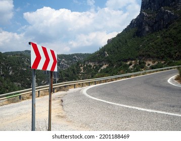 Right Curving Road And Traffic Sign. Three-arrow Traffic Sign. Focused On The Signboard.
     