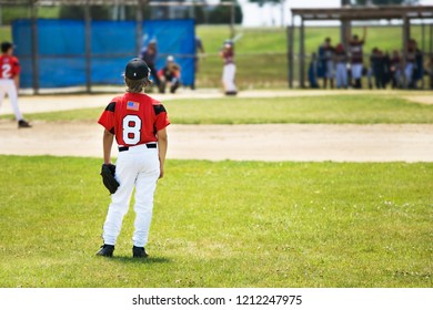 Right Fielder Looking Into The Infield At A Little League Baseball Game.