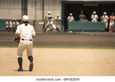 Right Fielder And Pitcher.Friends Watching Them In The Bench.