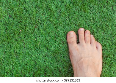 Right foot green grass background.