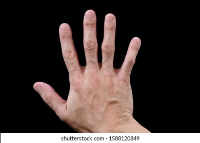 Right hand, adult male, facing downwards, showing back of hand, isolated on black background. Asian man's hand, fingers spread, palm down, dorsal view, lying on black surface. Closeup, top view.