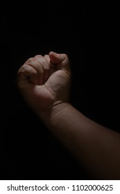 Right hand clutching the black background. - Shutterstock ID 1102000625