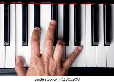 Right Hand Playing A C Minor Chord On The Piano