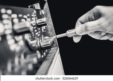 right hand plug in audio cord jack into studio gears, pre-amp, audio interface, effect signal processor. B&W filter + isolated on black for TV radio braodcasting, post production or music concept