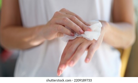 Right hand wipes left hand with piece of damp cloth closeup. Wet antibacterial hand wipes - Powered by Shutterstock