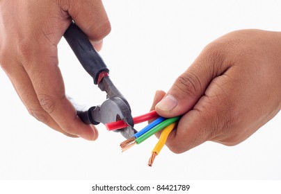 Right man's hand hold electrical cutter to strip electrical wire insulation. Left man's hand holding three striped electrical wire and one electrical wire ready to strip. isolated white background.