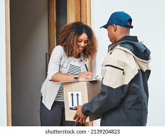 Right on time, every time. Shot of a young woman signing for her delivery from the courier.