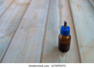 Right side photo of bottle and man and wooden background