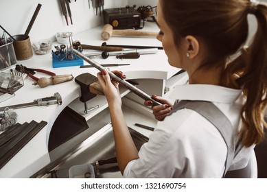 Right Size. Portrait Of Female Jewelry Designer Measuring A Ring With Metal Ring Sizer