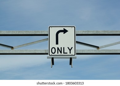 Right Turn Only Sign Against Blue Sky And Clouds.