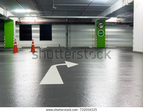 Right turn sign And exit sign\
Stuck on green pillars and mark the right turn in the parking\
lot.