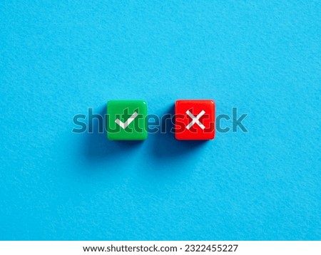Right versus wrong. To approve or to reject. Decision making concept. Checkmark and cross symbols on colorful cubes on blue background.