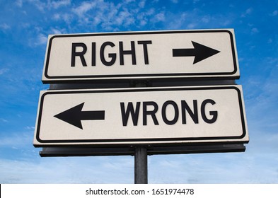 Right Vs Wrong. White Two Street Signs With Arrow On Metal Pole With Word. Directional Road. Crossroads Road Sign, Two Arrow. Blue Sky Background. Two Way Road Sign With Text.