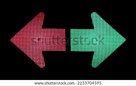 Right and wrong direction. Decision concept. Green arrow showing right and green arrow showing right on traffic lights on black background