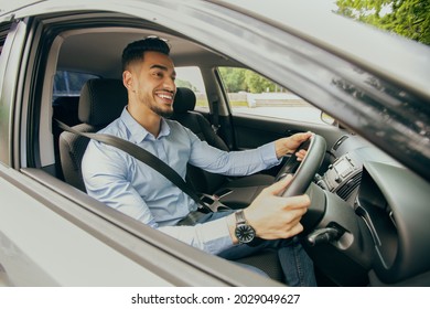 Right-hand Drive Auto Concept. Positive Middle-eastern Guy In Formal Outfit Going To Office, Driving Car, Happy Arab Businessman Enjoying His New Luxury Automobile, Shot From Outside