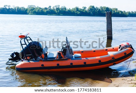 Rigid inflatable boat out on sea near an island on a sunny day