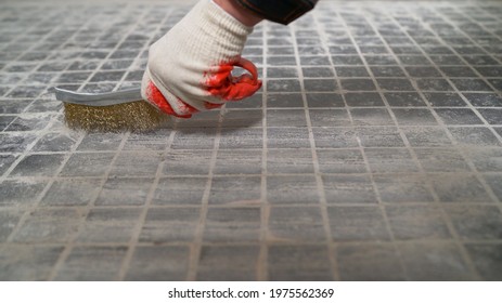 Rigid Metal Brush Attachment For Cleaning Hard Surfaces. A Worker Works With A Brush With Metallic Hair. Preparing The Sub-floor For Work.