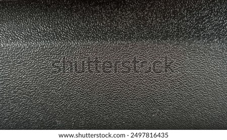 Rigid plastic with a rough texture, designed for durability and grip, featuring a patterned surface that adds both functionality and a distinctive look.