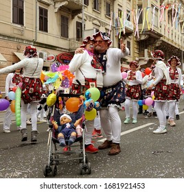 Rijeka, Croatia, February 23rd, 2020. Adults Masked Like A Babies Posing At The Carnival Parade