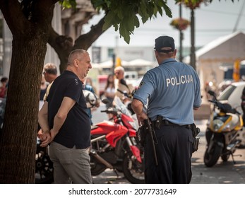 RIJEKA, CROATIA - JUNE 18, 2021: Croatian policeman, police offier from Croatian police forces, discussing in Rijeka. Croatian police, also known as MUP, or Policija