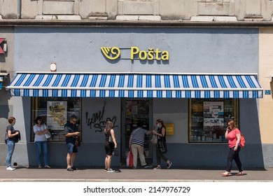 RIJEKA, CROATIA - JUNE 18, 2021: Logo of Hrvatska Posta on a local post office in Rijeka with people waiting. Hrvatska Posta or Croatian Post is public postal service of Croatia offering mail delivery