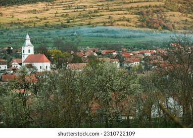 Rimetea is a small village located in Transylvania, Romania. It is situated in the Apuseni Mountains and is known for its picturesque setting and well preserved Hungarian architectural style. - Shutterstock ID 2310722109