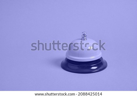 Ring alarm service pink metal bell on pink background. copy space