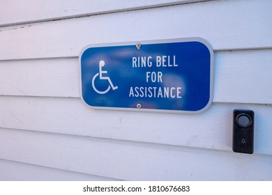 Ring Bell For Assistance Blue And White Sign With Wheelchair Icon